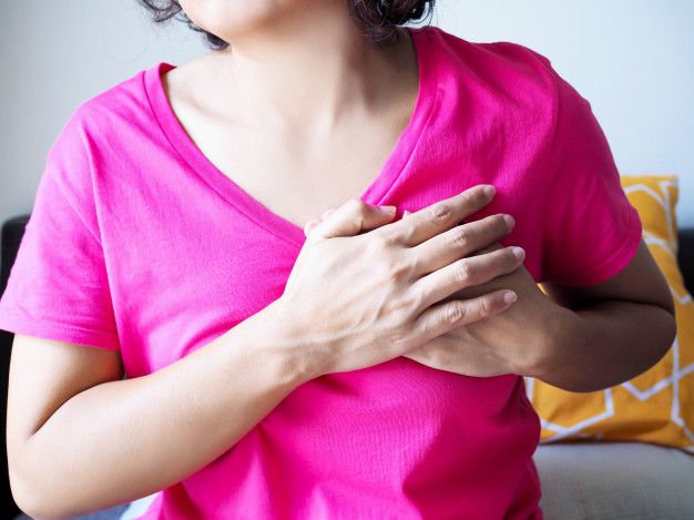 Asian young woman with acute chest pain from heart disease. Premium Photo